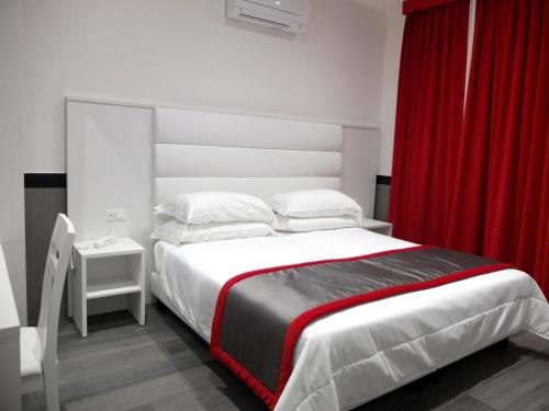 a bedroom with a large bed with a red curtain at ASTORIA GOLDEN GATE in Rome