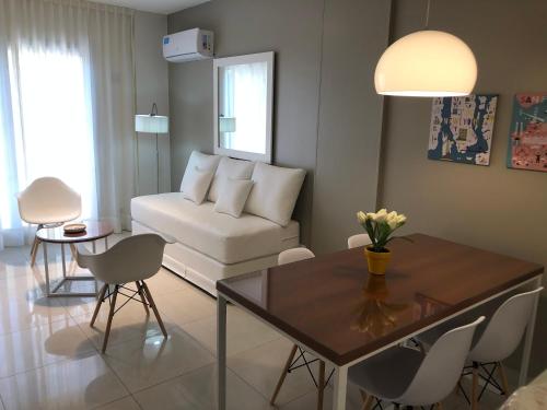 a living room with a white couch and a table at Edificio Celedonio Gutiérrez 651 in San Miguel de Tucumán