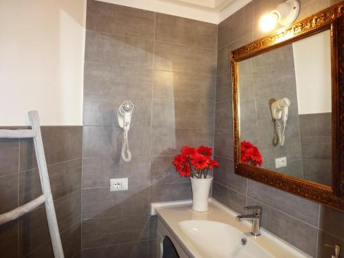 a bathroom with a mirror and a sink at SASSO BIANCO in Matera