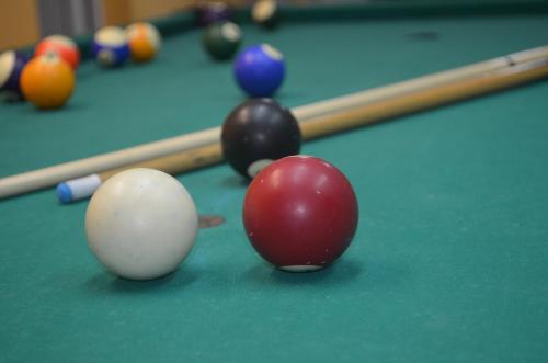 a group of billiard balls on a pool table at Pensiunea Magura in Baia Mare