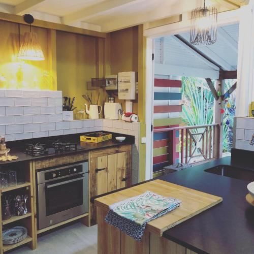 a kitchen with a stove and a counter top at Ti coin paradis in Anse-Bertrand