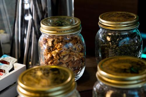 three glass jars filled with nuts on a table at Hotel Nazionale in Matera