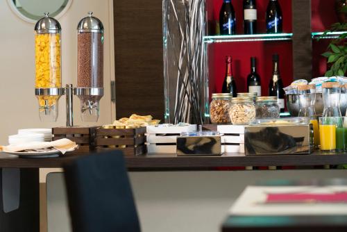 a table with food and bottles of wine on it at Hotel Nazionale in Matera