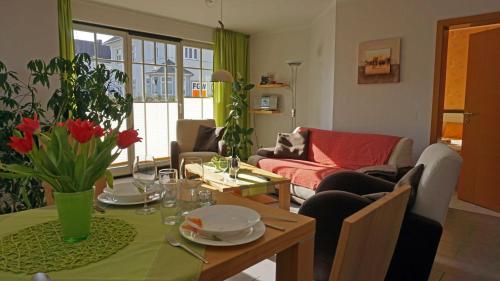 a living room with a table and a living room with a couch at Villa _Duenen vis a_ vis_ _ strand in Ahlbeck