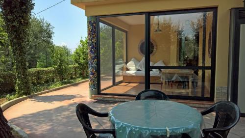 a glass table and chairs on a patio at Casa Vacanze La Caprignola in Buccino
