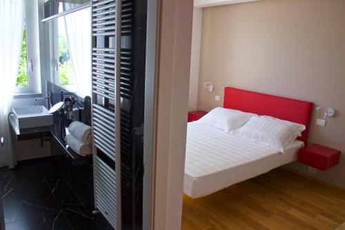 a bedroom with a bed with a red head board at Chiaroscuro in Belforte del Chienti