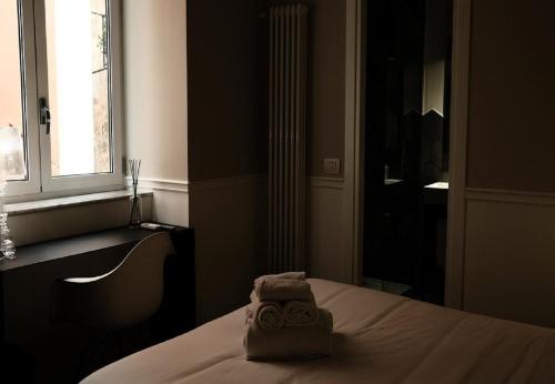 a room with a bed with a towel on it at KUKKA ROOMS in Naples