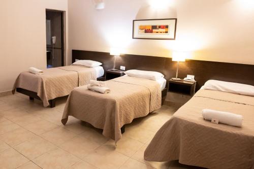 Postel nebo postele na pokoji v ubytování Hotel Solano