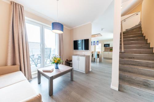 a living room with a couch and a table at AKZENT Apartmenthotel Binz in Binz