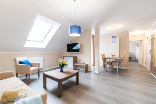 a living room with a couch and a table at AKZENT Apartmenthotel Binz in Binz