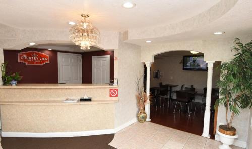 a restaurant lobby with a bar with a dining area at Country View Inn & Suites Atlantic City in Galloway