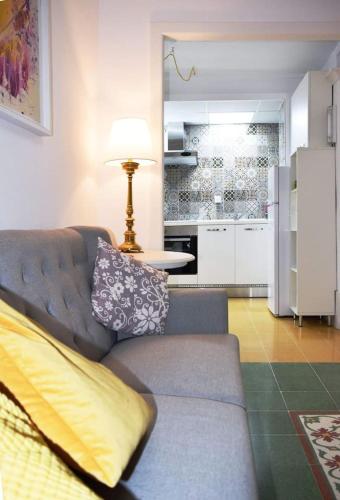 a living room with a couch and a kitchen at Private Apartment in Pembroke St Julians in Pembroke 