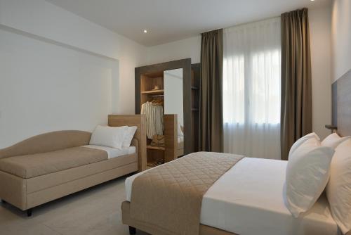 a hotel room with a bed and a couch at Hotel Ducale in Rimini