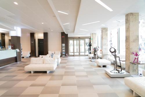 a lobby with couches and chairs in a building at Hotel Nazionale in Matera