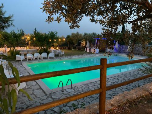 a swimming pool with a fence around it at Signor Cesare Agrobistrot B&B in San Giovanni Rotondo