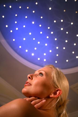 a woman is looking up at a blue ceiling at Hotel-Garni Jakober - B&B und Appartements in Tux
