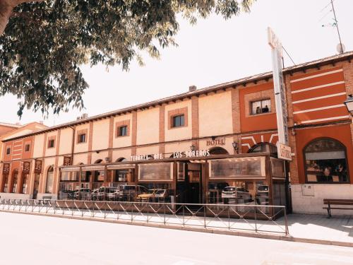 a building with cars parked outside of it on a street at Hotel Los Toreros in Tordesillas