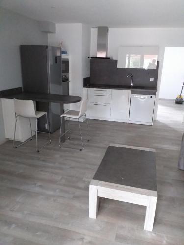 a kitchen with a table and chairs in a room at Chez Michel et Sylviane gite2 in Sélestat