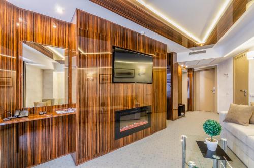 a living room with a fireplace and a tv on a wooden wall at Tourist Hotel Complex in Kyiv