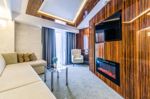 a living room with a couch and a tv at Tourist Hotel Complex in Kyiv