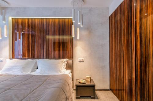 a bedroom with a bed and a large wooden wall at Tourist Hotel Complex in Kyiv