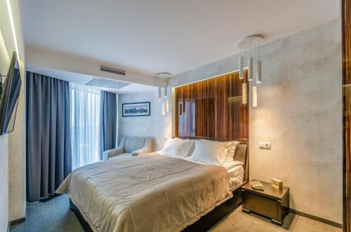 a hotel room with a bed and a chair at Tourist Hotel Complex in Kyiv