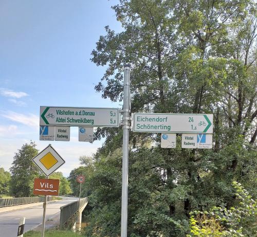 a pole with street signs on the side of a road at bei den Geißens in Aldersbach