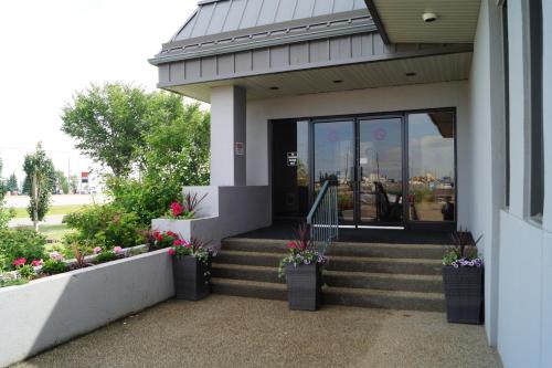 a building with stairs and potted plants on it at Radisson Hotel & Conference Centre Edmonton in Edmonton