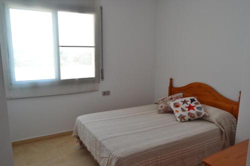 - une chambre avec un lit aux murs blancs et 2 fenêtres dans l'établissement Atico Mar y Montaña, à Sant Carles de la Ràpita