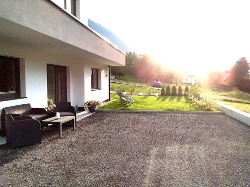 a patio of a house with a couch and a table at Living Apartment Maurer in Sautens