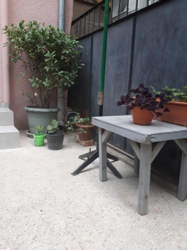 a picnic table with potted plants on a patio at agmashenebeli95 in Tbilisi City