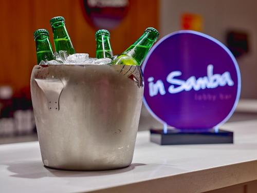 three bottles of beer in a bucket on a table at Rio Hotel by Bourbon Campinas in Campinas