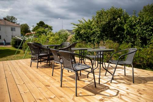 a group of chairs and a table on a deck at Klintvägen Apartments in Mariehamn