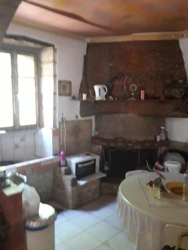 a living room with a fireplace and a table at VLASSIS APTS -ΜΕΛΙΔΟΝΙ-ΔΙΑΜΕΡΙΣΜΑ ΒΑΣΙΛΙΚΗ in Melidhónion