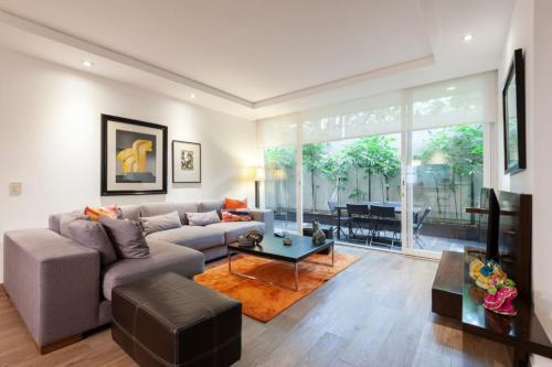 a living room with a couch and a table at Mi casa #2 at Polanco's most exclusive area in Mexico City