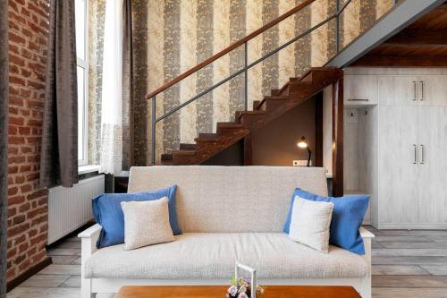 uma sala de estar com um sofá e uma escada em Cozy Studios on Freedom Square em Tbilisi