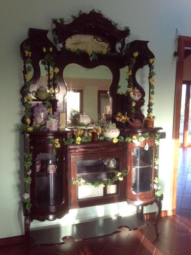 an old wooden cabinet with a mirror in a room at Magnolia House in Taurianova