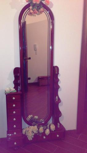 a large mirror on a dresser in a room at Magnolia House in Taurianova