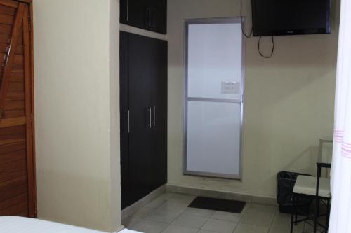 a kitchen with a white refrigerator in a room at Hotel Casablanca Tuxtla in Tuxtla Gutiérrez