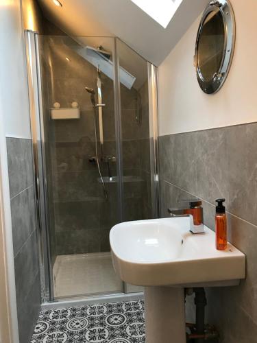 a bathroom with a sink and a shower at Bush House Accommodation - The Distillery in Bushmills