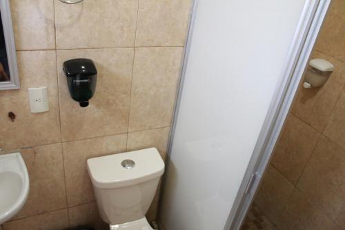 a small bathroom with a toilet and a sink at Hotel Casablanca Tuxtla in Tuxtla Gutiérrez