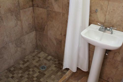a bathroom with a sink and a shower curtain at Hotel Casablanca Tuxtla in Tuxtla Gutiérrez