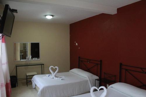 a room with two beds with hearts on them at Hotel Casablanca Tuxtla in Tuxtla Gutiérrez