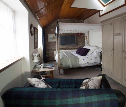a bedroom with a bed and a television at Langside Bed and Breakfast in Fenwick
