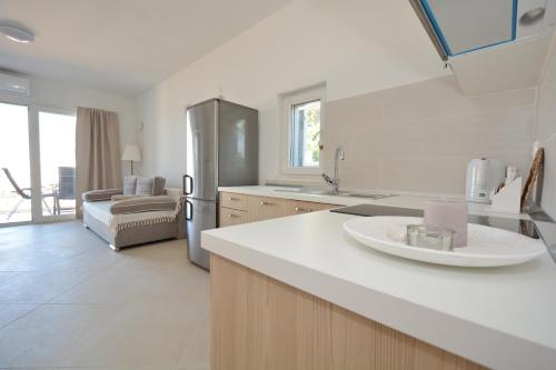 a kitchen with a refrigerator and a counter top at Apartments Piazza in Nin