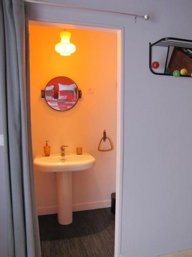 a bathroom with a sink and a mirror at La Gare De Millas Chambres d'hôtes in Millas
