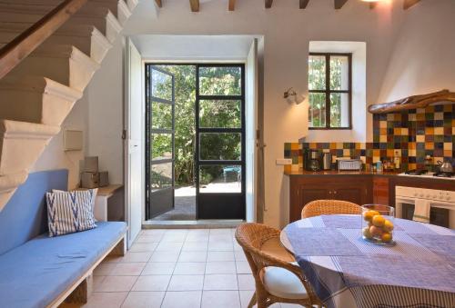 a kitchen and dining room with a table and chairs at Finca Ca'n Quatre in Sóller