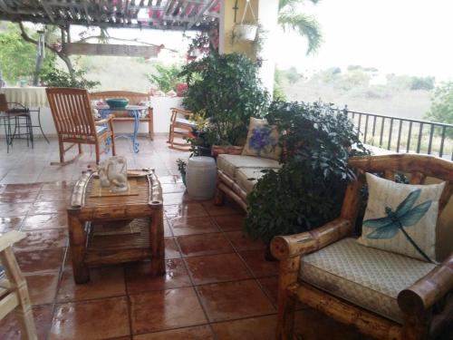 a patio with chairs and a table and a couch at Casa Bonita Inn in La Parguera