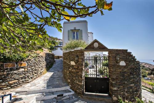 a gate to a house with a stone wall at Aegean Breeze in DYO CHORIA TINOS in Triandáros