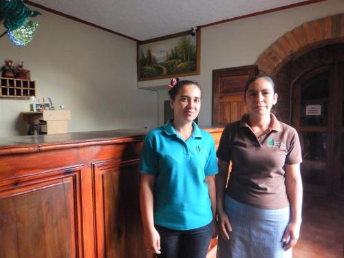 two women standing next to each other in a room at Hotel Buena Vista in Copán Ruinas